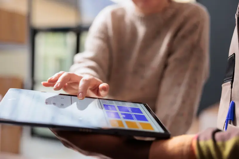 Patient reviewing medical weight loss progress on a tablet with a healthcare provider