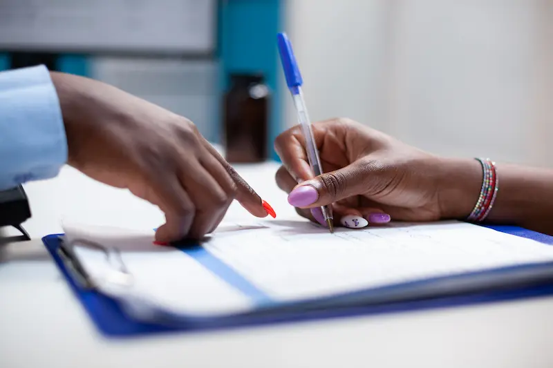 Patient completing paperwork for a personalized medical weight loss plan